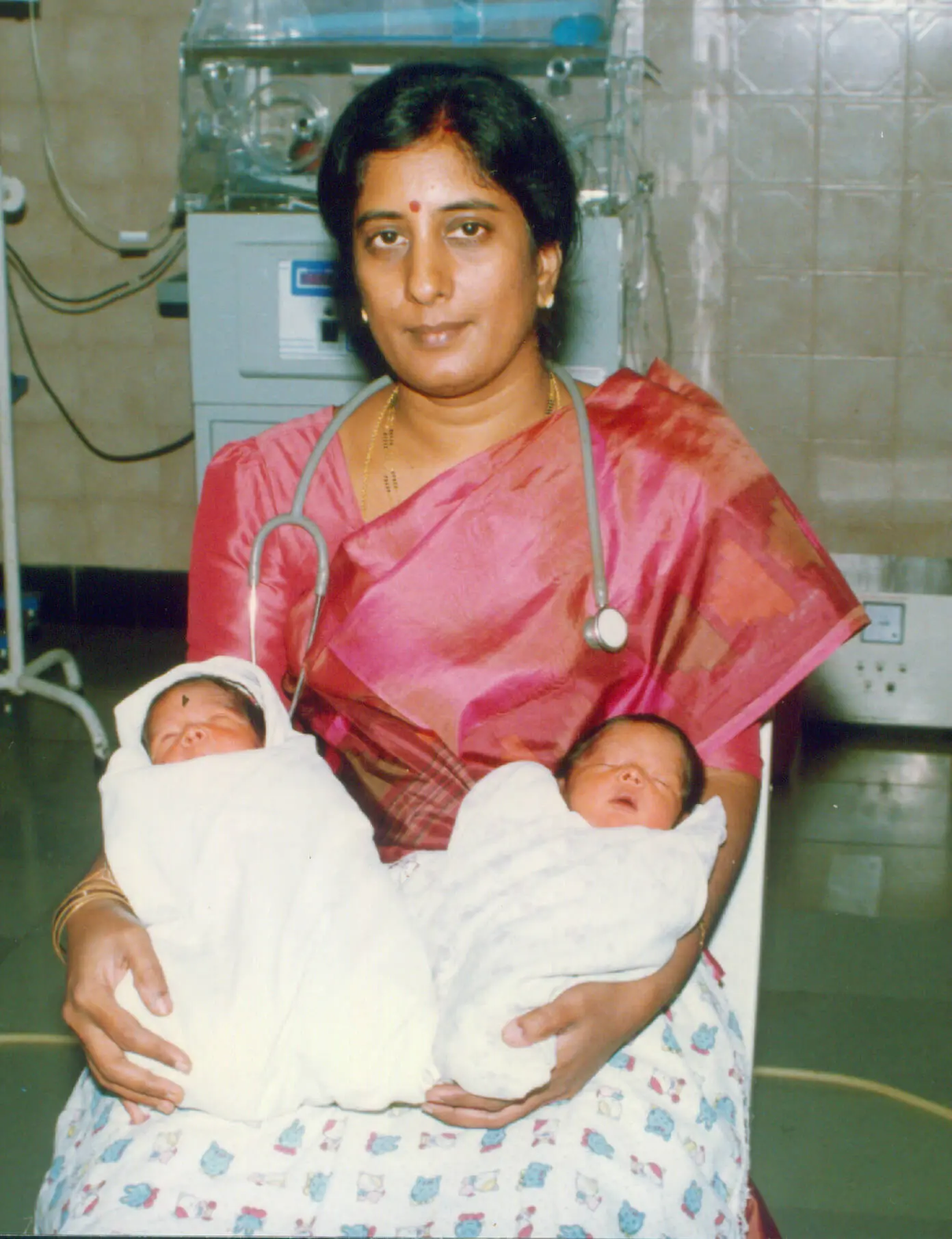Photo shows Dr. Rama Devi Kolli holding twin babies, they being the first ICSI babies of coastal Andhra Pradesh, born at our clinic in 2001.